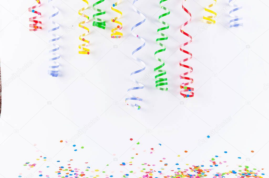Colorful assorted confetti with serpentine on white 