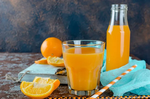 Orange juice in a glass and pieces — Stock Photo, Image