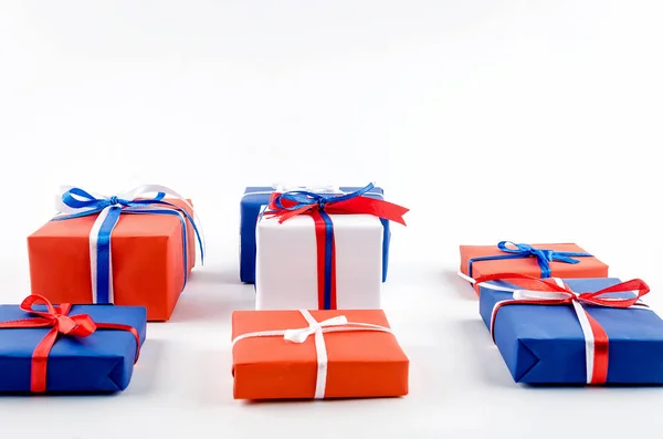 Red, blue and white gift boxes with ribbons on a white backgroun — Stock Photo, Image