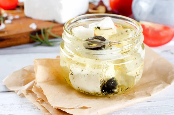 Marinated feta cheese in olive oil in jar — Stock Photo, Image
