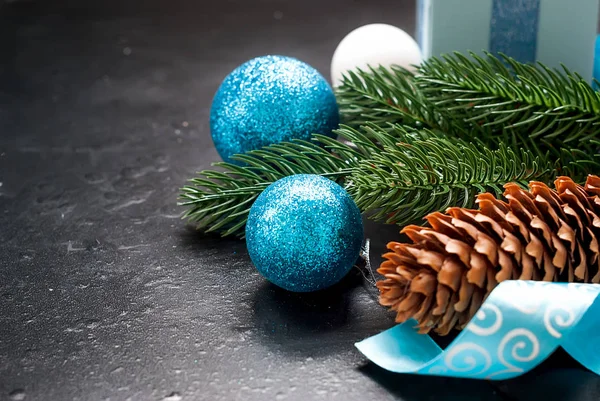 Christmas background with blue balls and fir branches