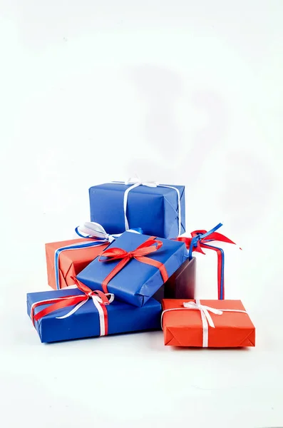 Red, blue and white gift boxes with ribbons on a white backgroun — Stock Photo, Image