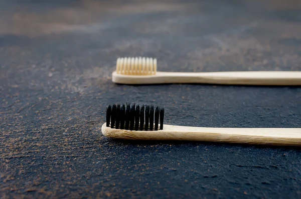 Bamboo toothbrush on dark concrete background — Stock Photo, Image