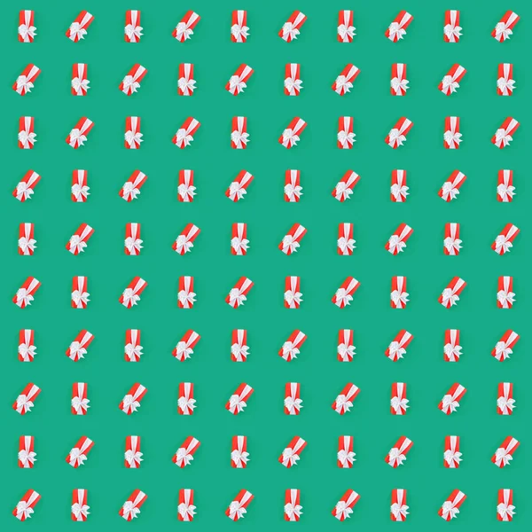 녹색 배경 위에 빨간색 선물 상자와 원활한 패턴 — 스톡 사진