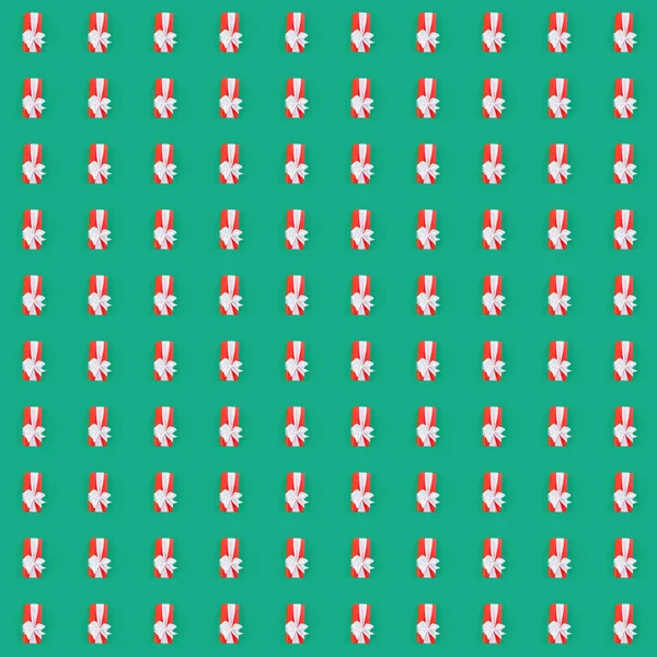 Seamless pattern with red gift box over the green background