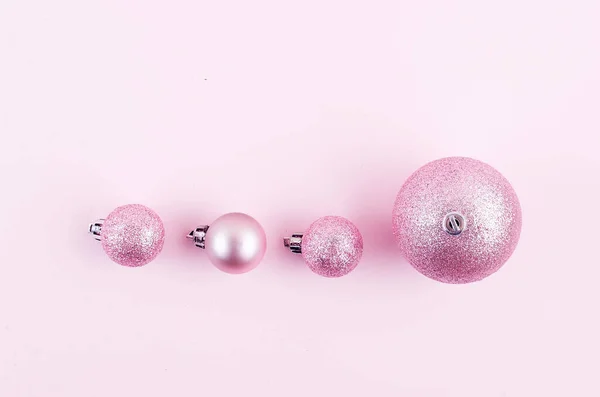 Pink christmas balls on pink paper background — Stock Photo, Image