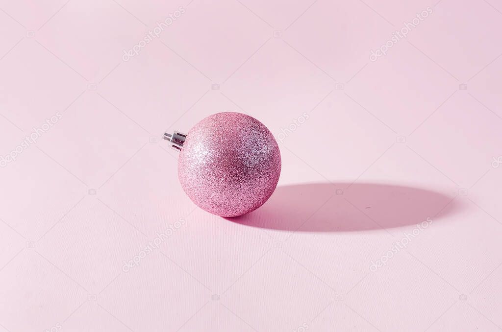 pink christmas balls on pink paper background