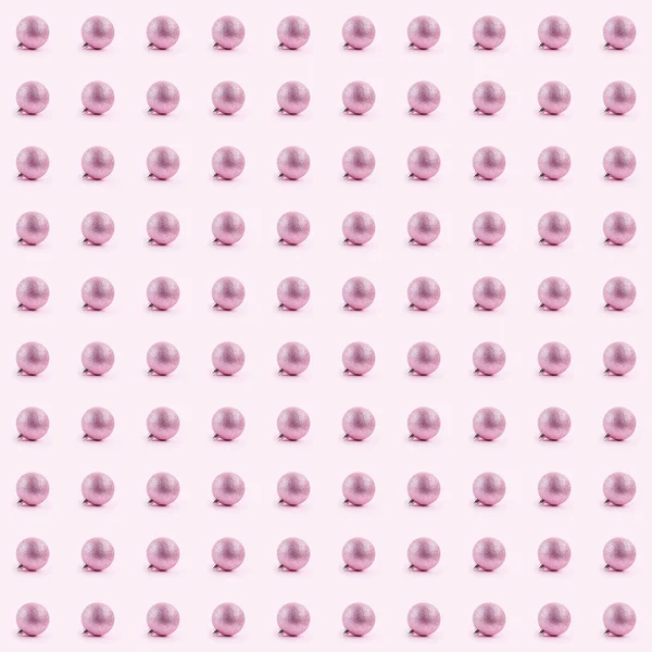Płynny wzór z różowymi kulkami świątecznymi na różowym papierze backgro — Zdjęcie stockowe