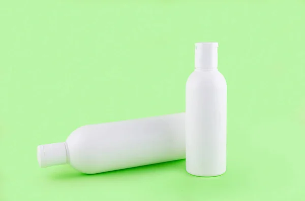 Two Cosmetic Bottles Green Background Set Cosmetic Products Cream Balsam — Stock Photo, Image