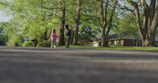 Kleine Kinder laufen die Straße hinunter — Stockvideo