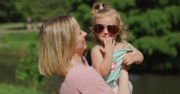 Junge schöne Frau hat Spaß mit ihrem kleinen Mädchen im Sommerpark. Zeitlupe 4k — Stockvideo