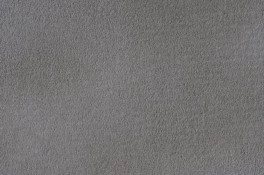 Çimento harcı ve arka planla sıvanmış gri desenli boyanmamış duvar