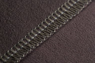 Giysilerin detayları, dikiş makinesi ile yapılır, bölümler ipliklerle işlenir.