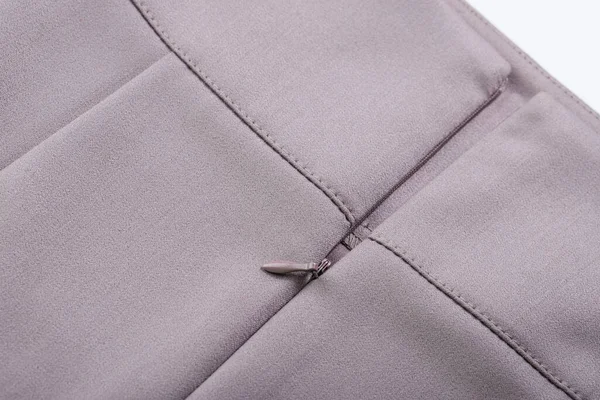 details of clothing, zipper in the stitched side seam of the skirt with a cut-off yoke, sections are covered with thread