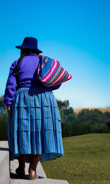 Colorful picture of native woman wearing traditional clothes in Copacabana, Bolivia