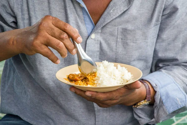 man eating rice with curry