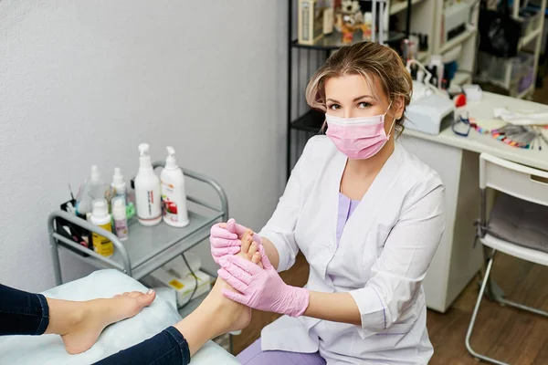 The pedicure specialist does the nail care work. Advance massage feet.