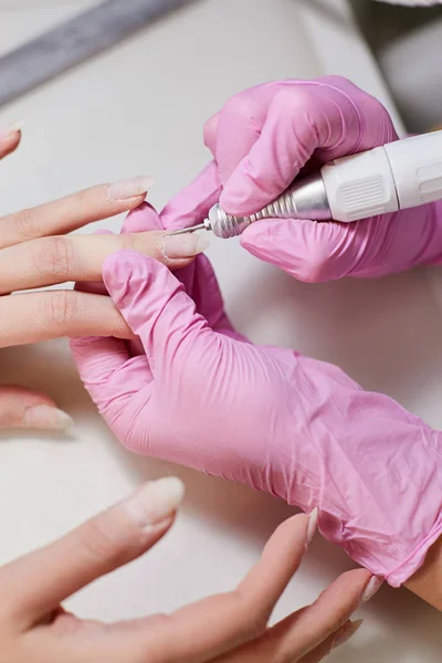 Polishing nails in the beauty salon master of manicure