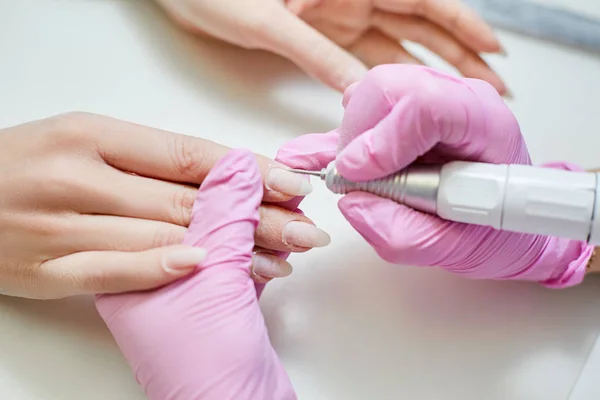 Polishing nails master in manicure in the beauty salon