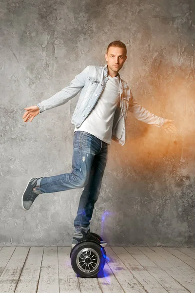 Young Handsome Guy Rides Hoverboard Studio Background Concrete Gray Wall — Stock Photo, Image