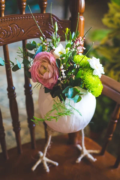 Decorative easter egg with flowers on an elegant chair