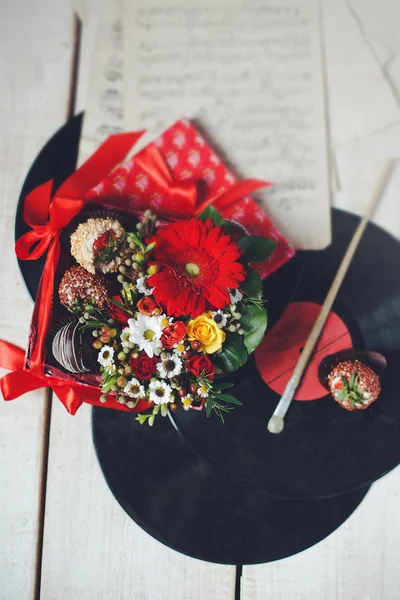 Gift set with decorative elements. Packing sweets with a bouquet