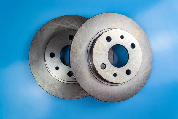 Auto parts, brake discs, pads. Two brake discs on a blue background