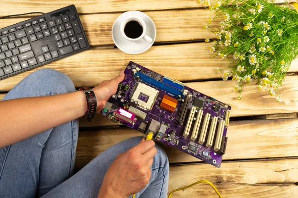 The wire is inserted into the motherboard. Wood background