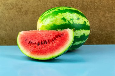 Taze kırmızı karpuz dilimlerinin yakın çekimi. Mavi arkaplan