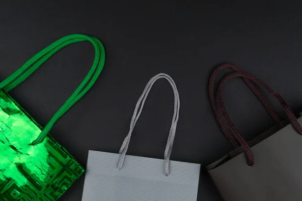 Gift bags on black background, black friday concept