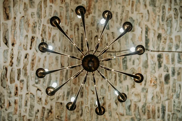 An ancient Middle Ages chandelier on a brick castle ceiling — Stock Photo, Image