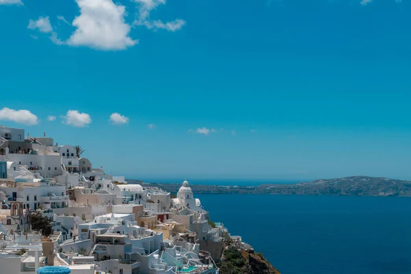 Santorini, Grecia. Pintoresca vista de las tradicionales casas cicládicas de Santorini en una pequeña calle con flores en primer plano. Ubicación: Oia village, Santorini, Grecia. Fondo de vacaciones . — Foto de Stock