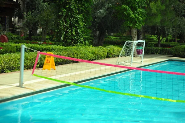 Swimming pool with stair and wooden deck at hotel. — Stock Photo, Image