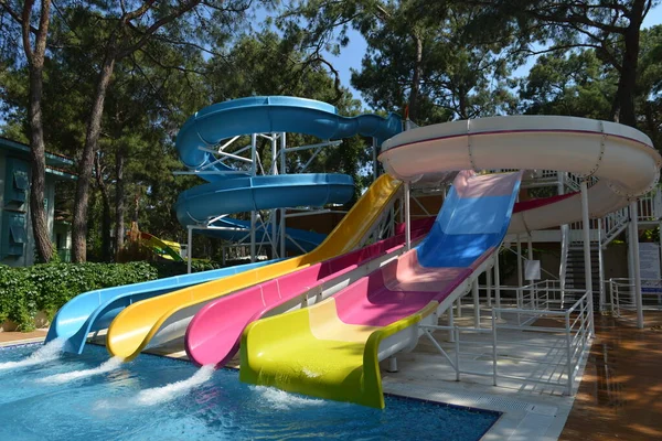 Little girl on water slide at aquapark during summer holiday — Stock Photo, Image