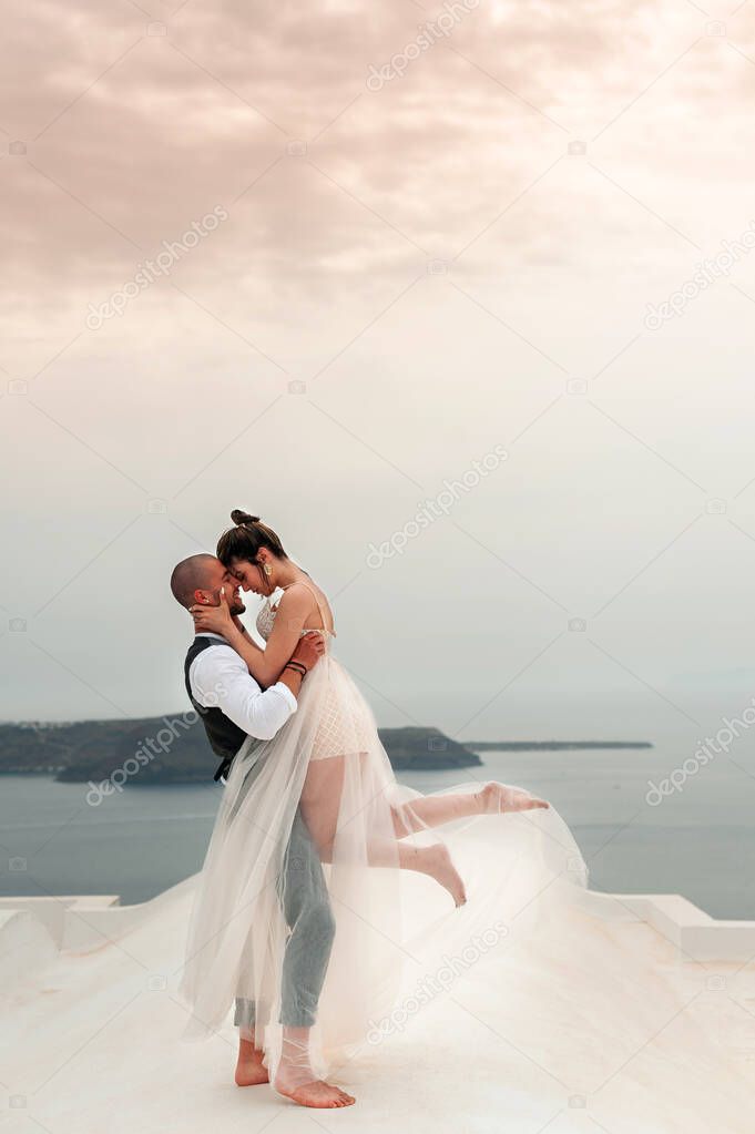 beautiful bride and groom in their summer wedding day on greek island Santorini