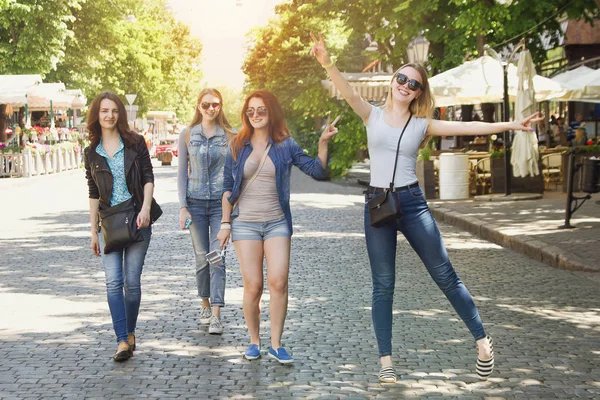 Four Happy Friends Walking Street Royalty Free Stock Photos