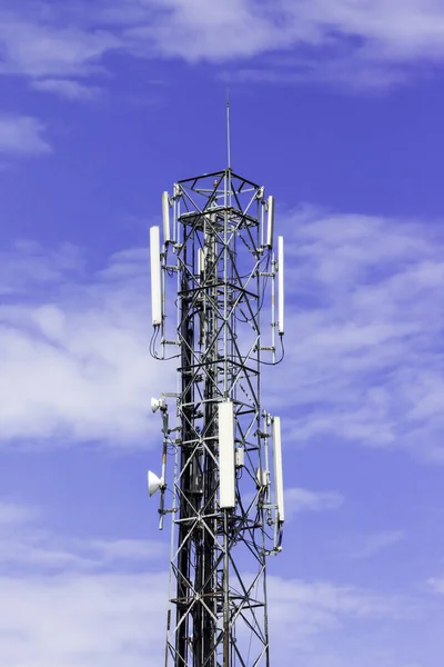 Radio telecommunication infrastructure tower against beautiful blue sky on background.