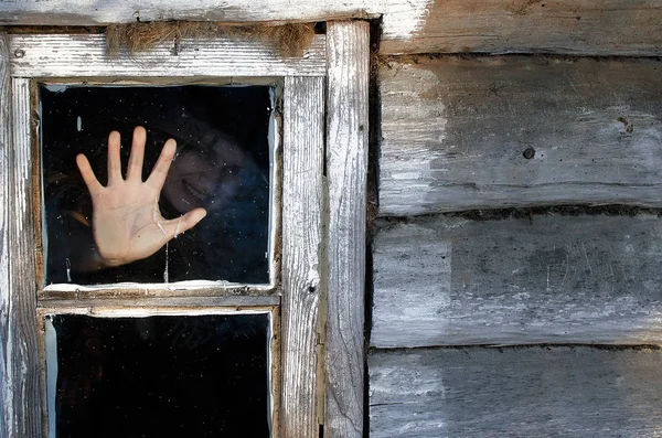 scary frame. a creepy witch laughs in the hut and stretches her hand to the window glass, she already rested against him, what will happen if she gets out of the window?!