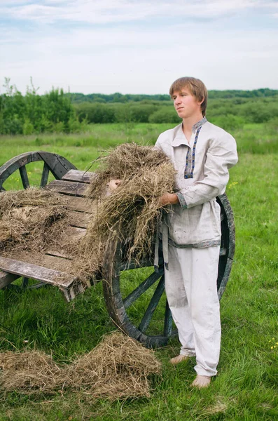 Young Man National Costume Stands Old Hay Cart Holds Armful — Stock Photo, Image