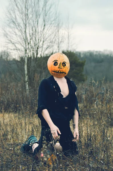 Espantalho Halloween Com Uma Abóbora Cabeça Está Ajoelhado — Fotografia de Stock