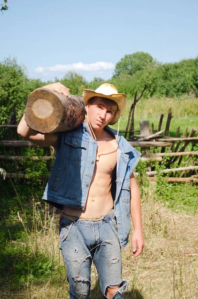 Молодой Человек Ковбойской Шляпе Тащит Большое Тяжелое Бревно Ферме — стоковое фото
