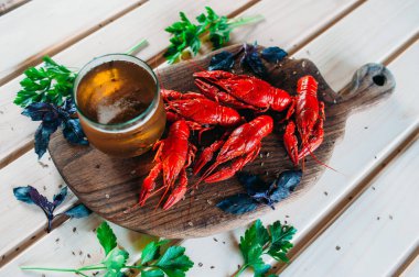 Kerevit kırmızı mutfak tahtası fesleğen dereotu ile bir bardak bira ile haşlanmış