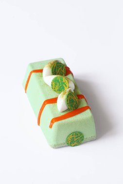 Beyaz arka plan üzerinde tropikal meyve ile çağdaş yeşil çay Mousse kek.