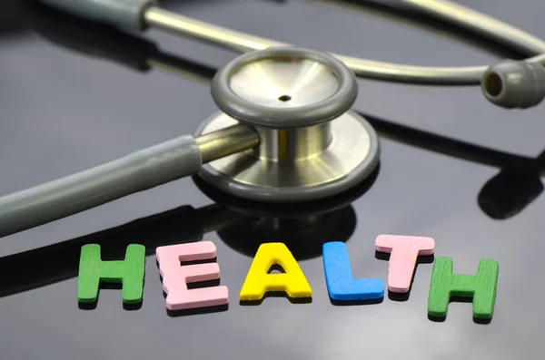 Health Letter Stethoscope Dark Background — Stock Photo, Image
