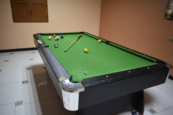 Bilardo masasında ıstaka ve toplar. Yeşil bilardo arka planı