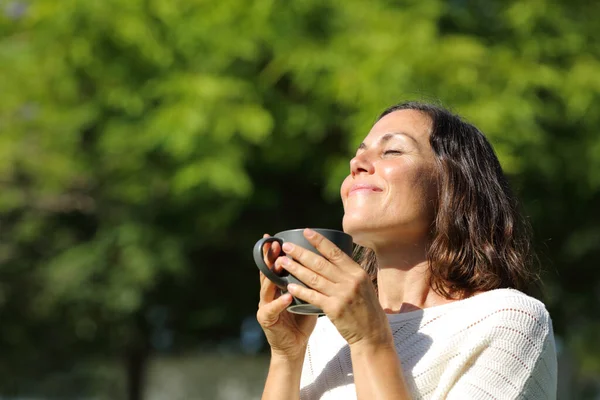 Satisfied Adult Woman Smelling Coffee Cup Standing Green Park Summer — Stock Photo, Image