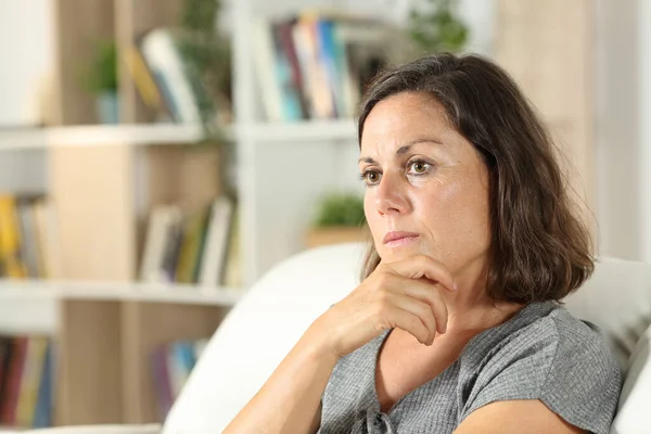 Pensive Adult Woman Looking Away Sitting Away Sofa Living Room — стоковое фото