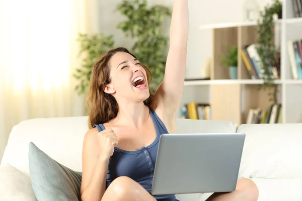 Excited Woman Celebrates Good News Laptop Sitting Couch Living Room Royalty Free Stock Photos