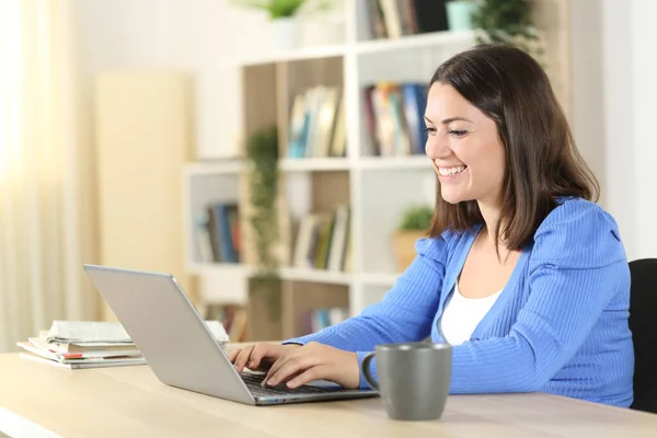 Szczęśliwa Kobieta Pisząca Laptopie Siedząc Stole Salonie Domu — Zdjęcie stockowe