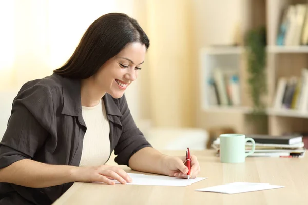 Donna Felice Scrivere Lettera Tavolo Casa Con Una Luce Calda — Foto Stock